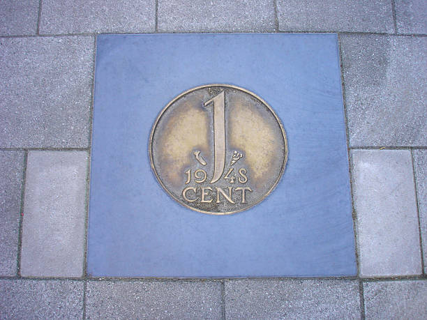 istock coin of one cent in pavement 180359418
