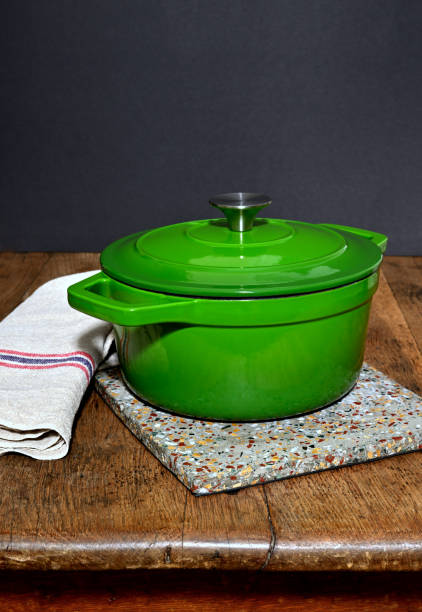 istock Green enamelled stewpan on a table 1803596715