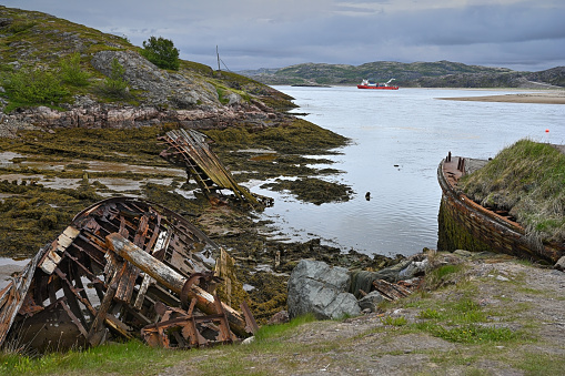 Cemetery of old abandoned ships on the coast of the Barents Sea in Teriberka. Northern Russia