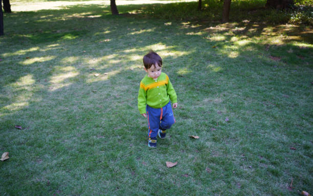 istock Mixed race children standing on the grass 1803600528