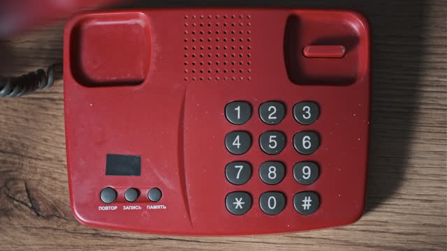 Calling 911 On an Old Retro Red Telephone with Dial Buttons Top View