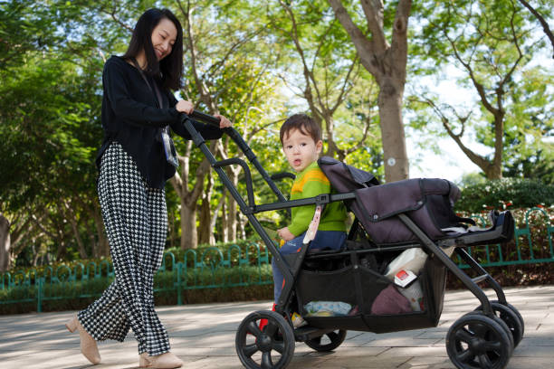 istock Women Pushing stroller with Children 1803612295