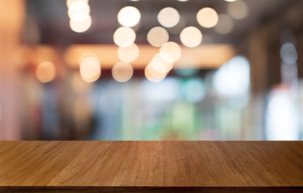 istock Mock up for space. Empty dark wooden table in front of abstract blurred bokeh background of restaurant . can be used for display or montage your product 1803630309