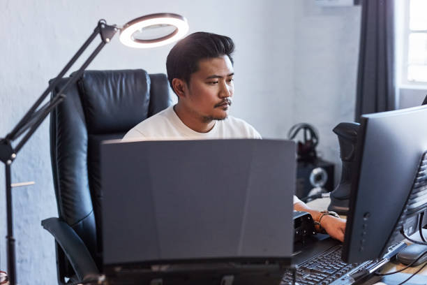 istock Computer, serious and business man typing at desk, working on software project or reading email in creative startup. Professional programmer coding on technology, planning and communication in office 1803636747