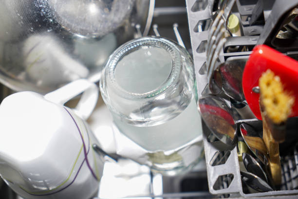istock Dishwasher with freshly washed plates, glasses and cutlery 1803638461