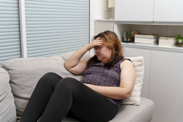 istock Sad Overweight plus size woman thinking about problems on sofa upset girl feeling lonely and sad from bad relationship or Depressed woman disorder mental health 1803640161