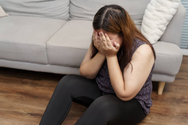 istock Sad Overweight plus size woman thinking about problems on sofa upset girl feeling lonely and sad from bad relationship or Depressed woman disorder mental health 1803644250