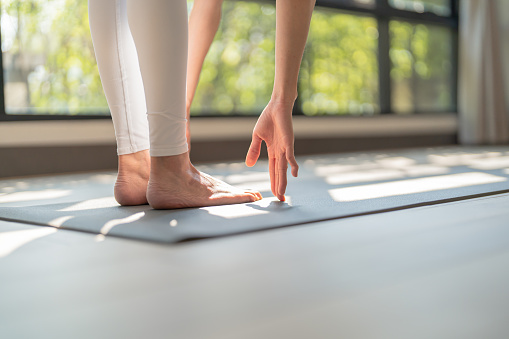 Fitness asian woman doing yoga stretching exercise on mat yoga fitness exercises. Healthy lifestyle Calmness and relax at yoga studio.