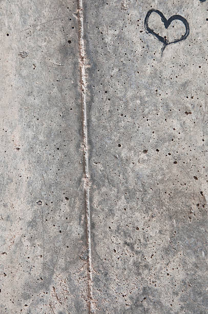 istock Black Heart on Concrete Background 180365397