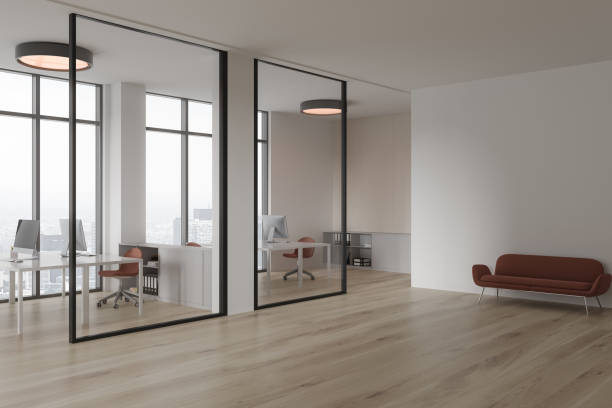 istock White office interior with workspace and chill zone, glass partition and window 1803661378