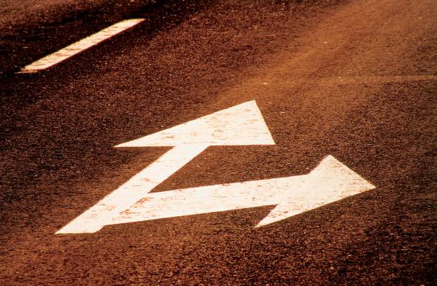 istock Asphalt arrows pointing in different directions. 1803682740