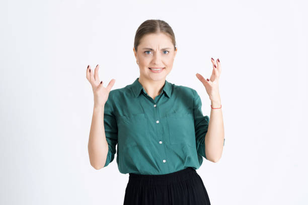 Attractive young woman has lost control and she is very angry and aggressive isolated on a white studio background. Unhappy facial emotion Attractive young woman has lost control and she is very angry and aggressive isolated on a white studio background. Unhappy facial emotion. scotiabank saddledome stock pictures, royalty-free photos & images