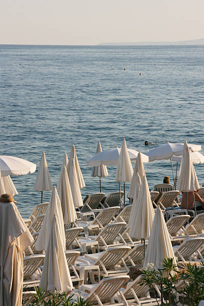istock Closed and opened Beach sunshade in Nice, french riviera. 180371230
