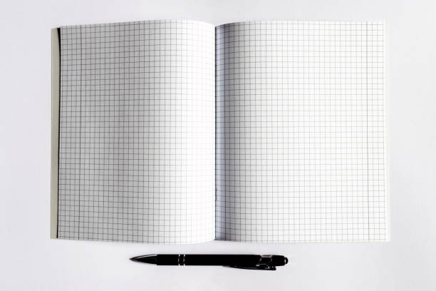 istock Top view Checkered notebook with a black pen on a white background. Place for text.Copy space. 1803720194