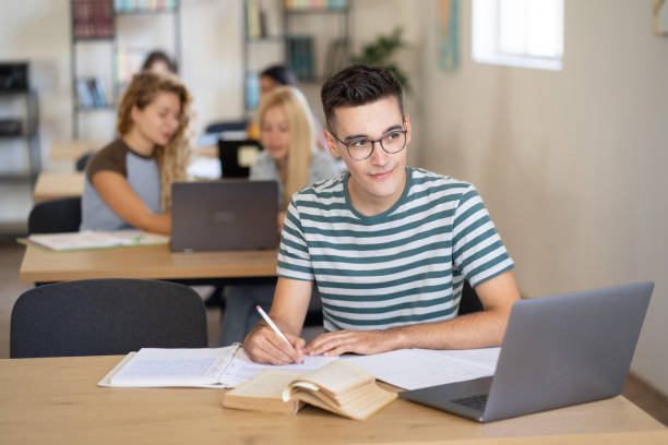 istock A young student is doing his homework in the library 1803723972