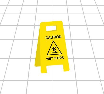 Wet Floor Caution Sign On Tiled Floor