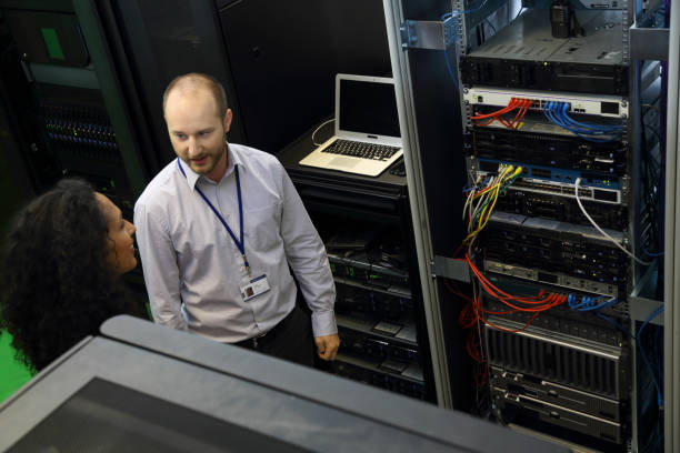 istock IT professionals having meeting in server room 1803726735