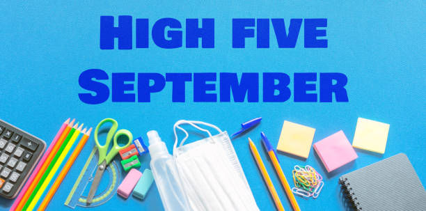 istock School supplies coronavirus prevention items.High five september text. Bottom border on a blue tissue background. 1803730791