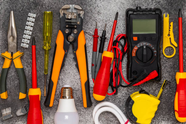 istock Electrician equipment on marble background with copy space.Top view.Electrician tool set.Multimeter, tester,screwdrivers,cutters,duct tape,lamps,tape measure and wires.Flet lay. Construction concept. 1803751922