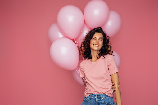 Woman is holding pink air balloons