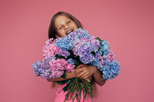 Cute teenager girl holding flowers