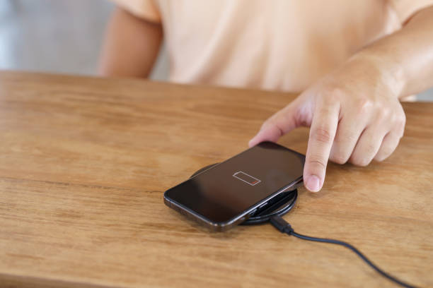 istock Charging mobile phone battery with wireless charging device in t 1803775947