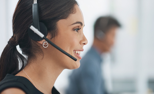 Happy woman, face and profile with headphones in call center for customer service or telemarketing at office. Closeup of female person, consultant or agent smile in online advice or help at workplace