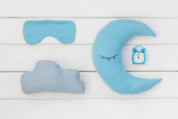 istock Alarm with soft moon pillow. Insomnia concept background 1803777716