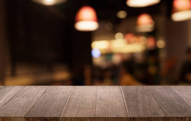 istock Mock up for space. Empty dark wooden table in front of abstract blurred bokeh background of restaurant . can be used for display or montage your product 1803780531