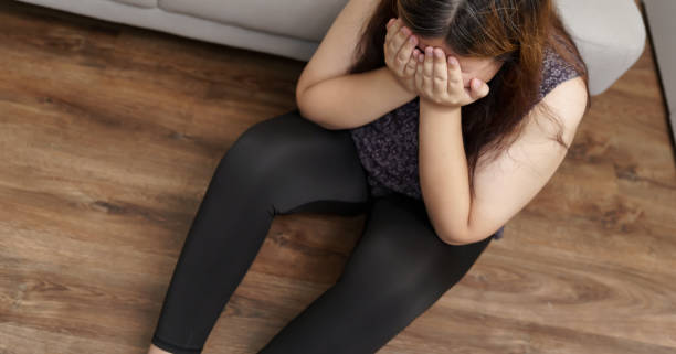 istock Sad Overweight plus size woman thinking about problems on sofa upset girl feeling lonely and sad from bad relationship or Depressed woman disorder mental health 1803780545