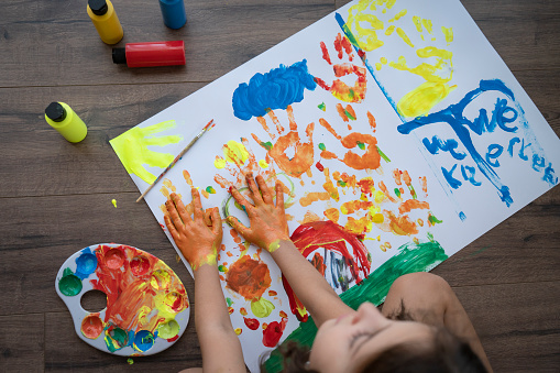 Little girl painting a picture