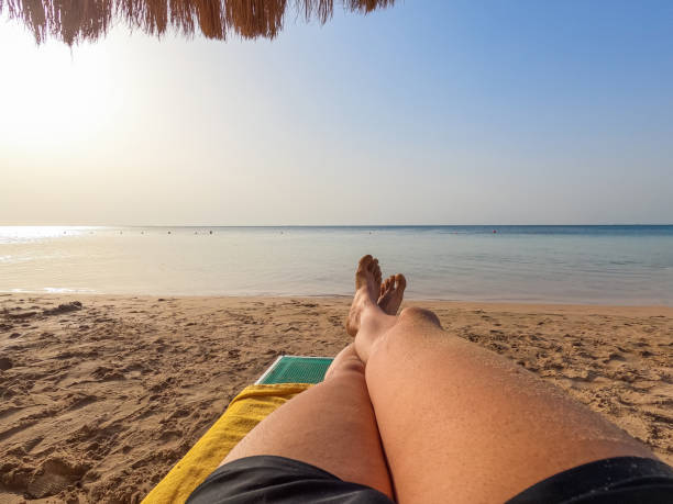 istock Young Man's Feet As He Is Relaxing On The Beach In Egypt 1803793141