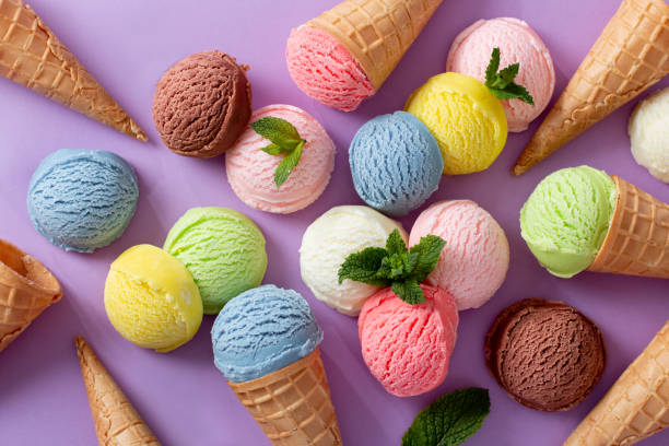istock Pastel colored ice cream scoops and cones frame on pastel violet background 1803794045