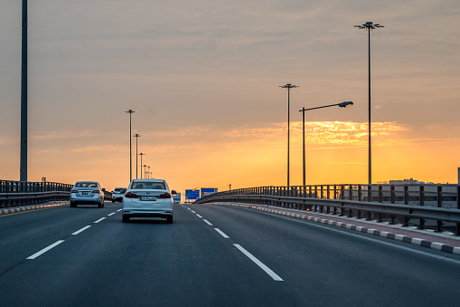 Doha, Qatar - November 16, 2023: Sunset view Salva Road. Saleh Bin Nasser Al Thani intersection. Roads and Traffic Doha.