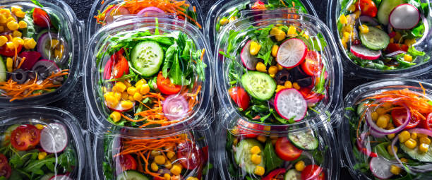 istock Boxes with pre-packaged vegetable salads in a commercial fridge 1803801495