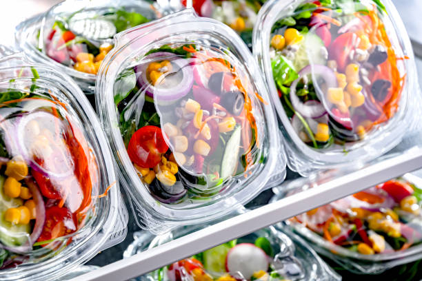 istock Boxes with pre-packaged vegetable salads in a commercial fridge 1803802058