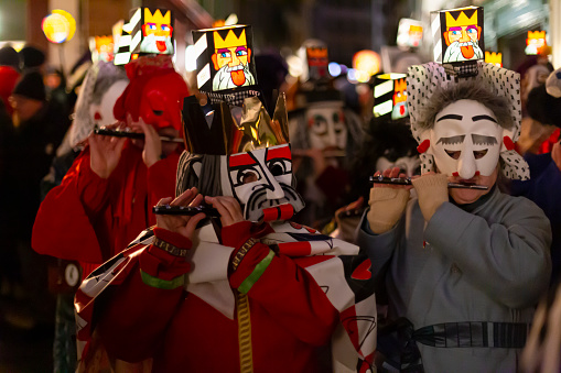 Basel, Switzerland - February 27th 2023. Close-up of piccolo players in their costumes with illuminated head lanterns.