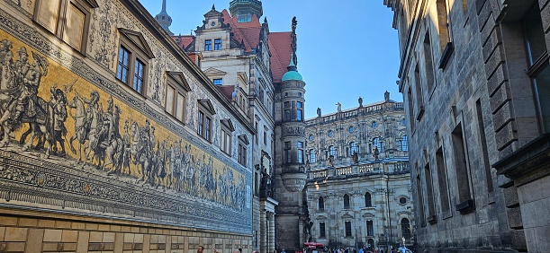 Dresden, Germany – September 2, 2023: The Fürstenzug, a long street mural depicting the history of Saxony’s ruling family, the Wettins, in Dresden,  Germany.