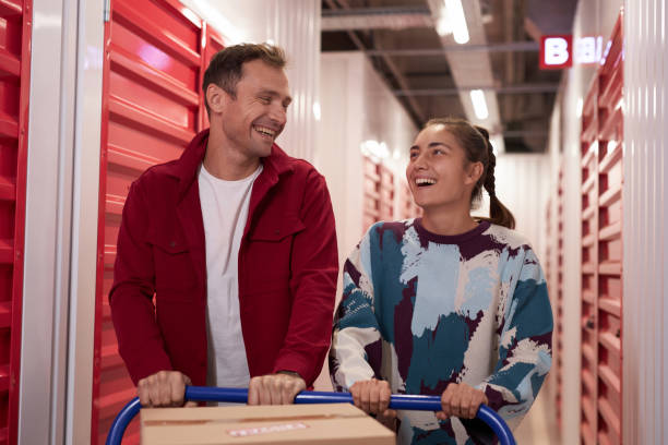 istock Couple Pushing Cart to Storage Unit 1803816932