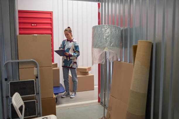 Woman Checking List when Storing Belongings