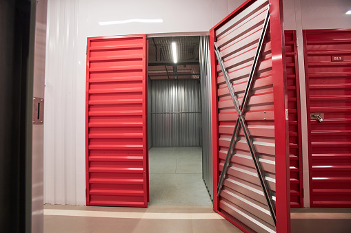 Opened doors of empty self-facility storage unit prepared for customer