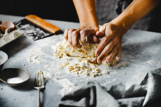 istock Close-up of hands kneading pasta dough on kitchen counter 1803824125