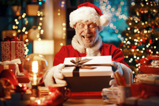 istock Happy Santa Claus preparing gifts 1803843400