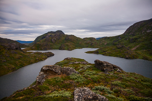 The high angle view of a loch in a remote rural area of Dumfries and Galloway, south west Scotland. Although it is summer the sky is overcast with grey clouds after a shower of rain. The panorama was created by merging several images together.