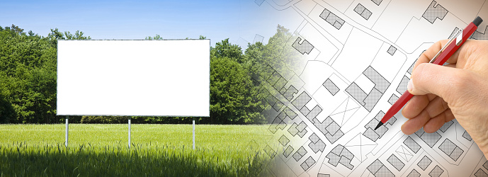 Advertising billboard in a rural scene with copy space - Vacant Land for the construction of residential buildings - Construction industry concept with an imaginary cadastral map