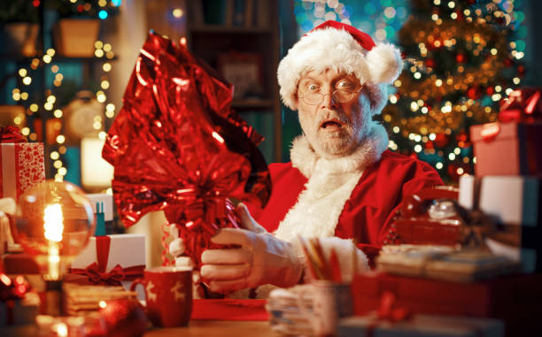 istock Funny Santa Claus holding an Easter egg 1803857454