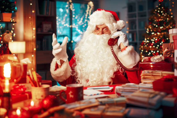 istock Happy Santa Claus having a phone call 1803863019