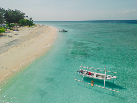 Tourboat anchored near beach in turquoise sea