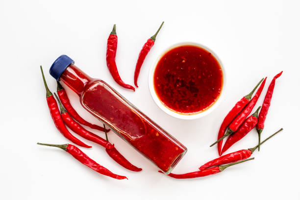 istock Red chili sauce ketchup or tabasco with ripe hot pepper 1803872258