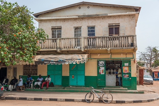 Banjul, Gambia - May 09, 2017: Shops and old colonial house in a central street of the city